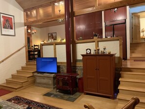 Living room looking into kitchen.SMART TV. Glass French doors provide river view