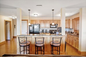 Dishwasher, coffee/tea maker, cookware/dishes/utensils, dining tables