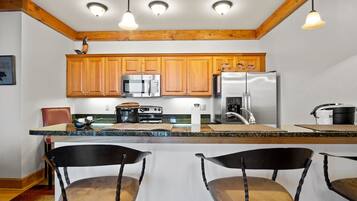 Dishwasher, coffee/tea maker, cookware/dishes/utensils, dining tables
