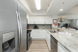 Fridge, dishwasher, coffee/tea maker, cookware/dishes/utensils