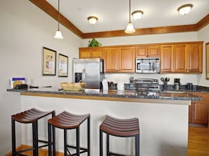 Dishwasher, coffee/tea maker, cookware/dishes/utensils, dining tables