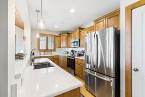 Dishwasher, coffee/tea maker, cookware/dishes/utensils, dining tables