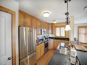 Dishwasher, coffee/tea maker, cookware/dishes/utensils, dining tables