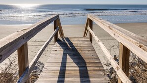 A wooden boardwalk leading to a beach with the ocean in the background. - Stay @ Sea Cookie! Classic, Updated Beach Home (Folly Beach)