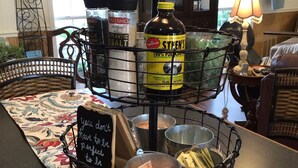 A dining table with a central stand holding various condiments and a chalkboard sign.