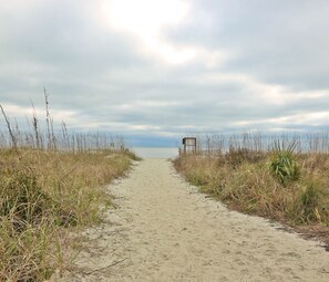 A sandy path leading to a beach with a wooden structure on the right. - 301 North Shore End Unit, No carpet, CLEAN, Wrap-around Balcony, Nov. Avail. (Hilton Head Island)