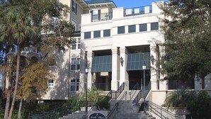 A multi-story building with a grand entrance, a staircase, and a sign indicating it is a hotel. - 301 North Shore End Unit, No carpet, CLEAN, Wrap-around Balcony, August Avail. (Hilton Head Island)