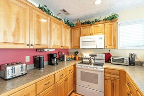 Dishwasher, coffee/tea maker, cookware/dishes/utensils, dining tables