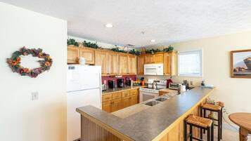 Dishwasher, coffee/tea maker, cookware/dishes/utensils, dining tables