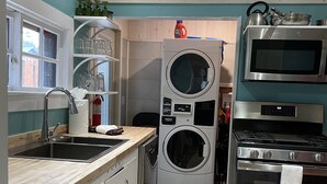 A compact kitchen with a sink, a washing machine, an oven, and a microwave. - Family Friendly, Close To Downtown, Best views of Longs Peak and the Range (Estes Park)