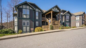 A multi-story building with a prominent balcony and a sign indicating parking availability. - Wintergreens R611- Mtn Condo/View, Gated Resort, Indoor/Outdoor Pools & Hot Tub (Banner Elk)