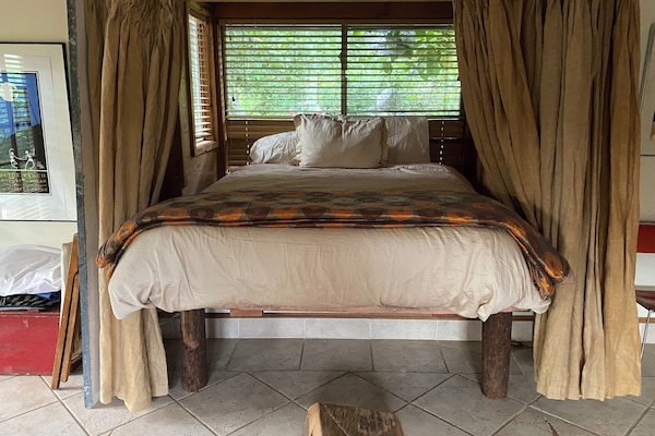 Queen bed with privacy curtain.