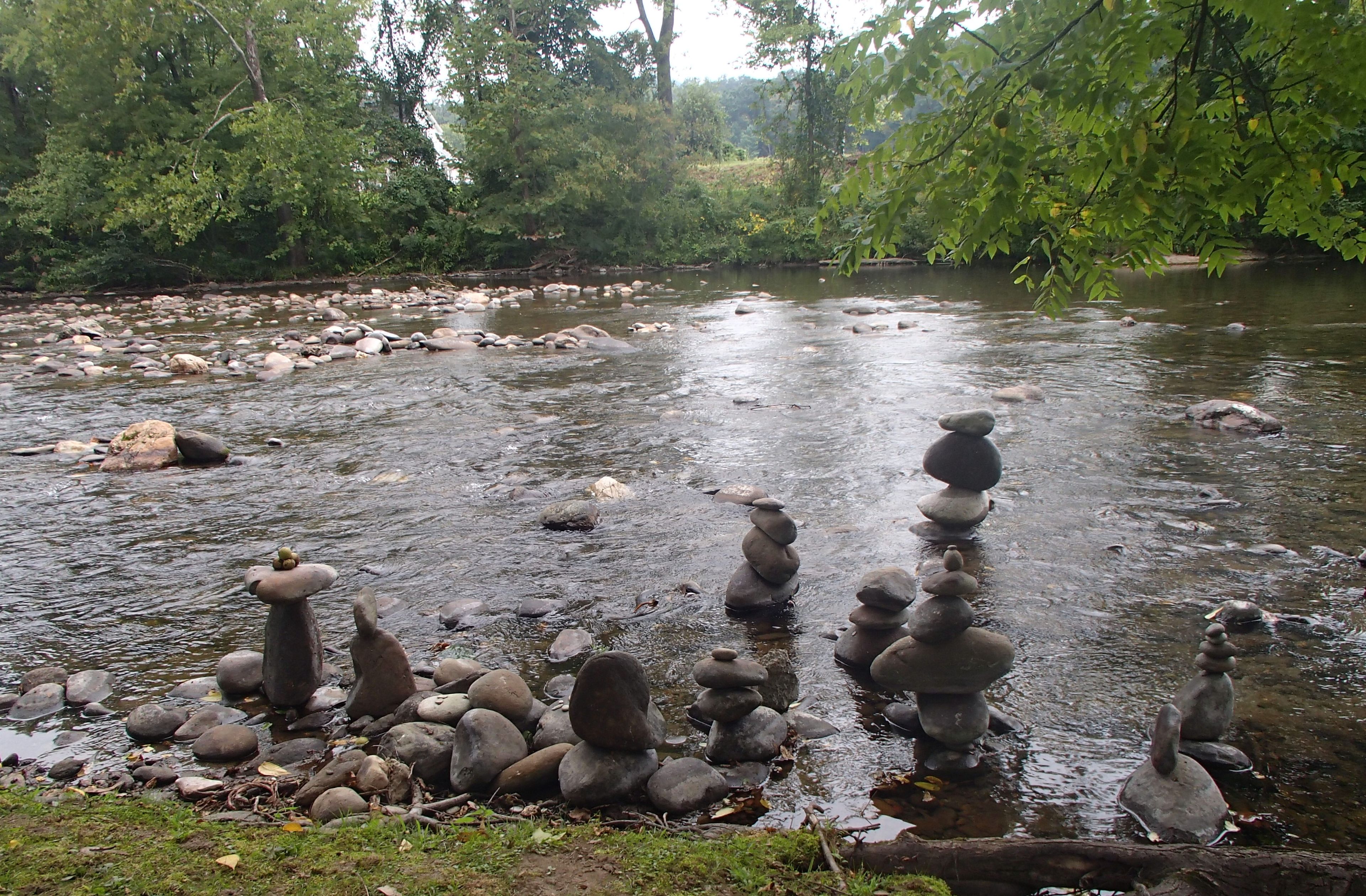 A river with rocks stacked in a traditional balance formation.