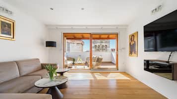 Luxury Apartment | Living area | 50-inch flat-screen TV with cable channels, Smart TV