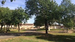 A residential area with houses, trees, and a paved driveway. - Les Sentiers du Causse  (Lentillac-du-Causse)