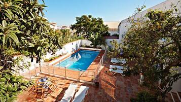 Seasonal outdoor pool, pool umbrellas, pool loungers