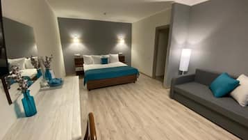 Luxury Room, Multiple Beds | Living room | Flat-screen TV