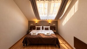 A hotel room with a large bed, two bedside tables, a headboard, and a window with curtains. - Hotel & SPA Pysanka (Lviv)