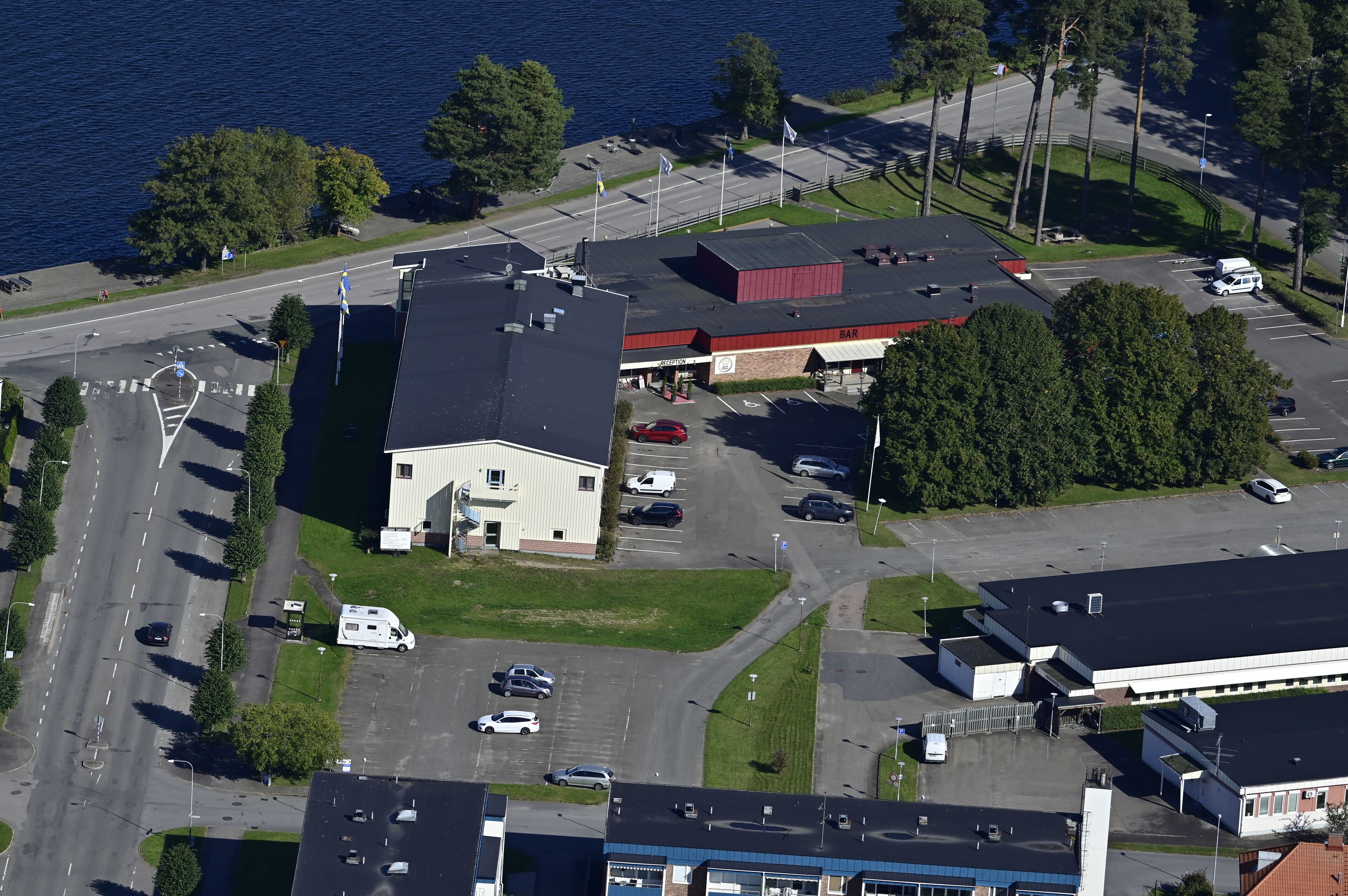 An aerial view of a commercial area with a building labeled "VINEGAR HILL BAR" and a parking lot with several cars.
