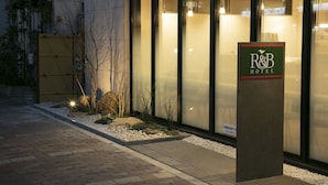 A hotel entrance with a sign reading "R&B HOTEL".