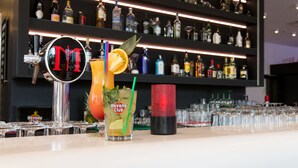 A bar area with a variety of bottles and glasses, a tap labeled "DT", and a sign that reads "Havana Club".