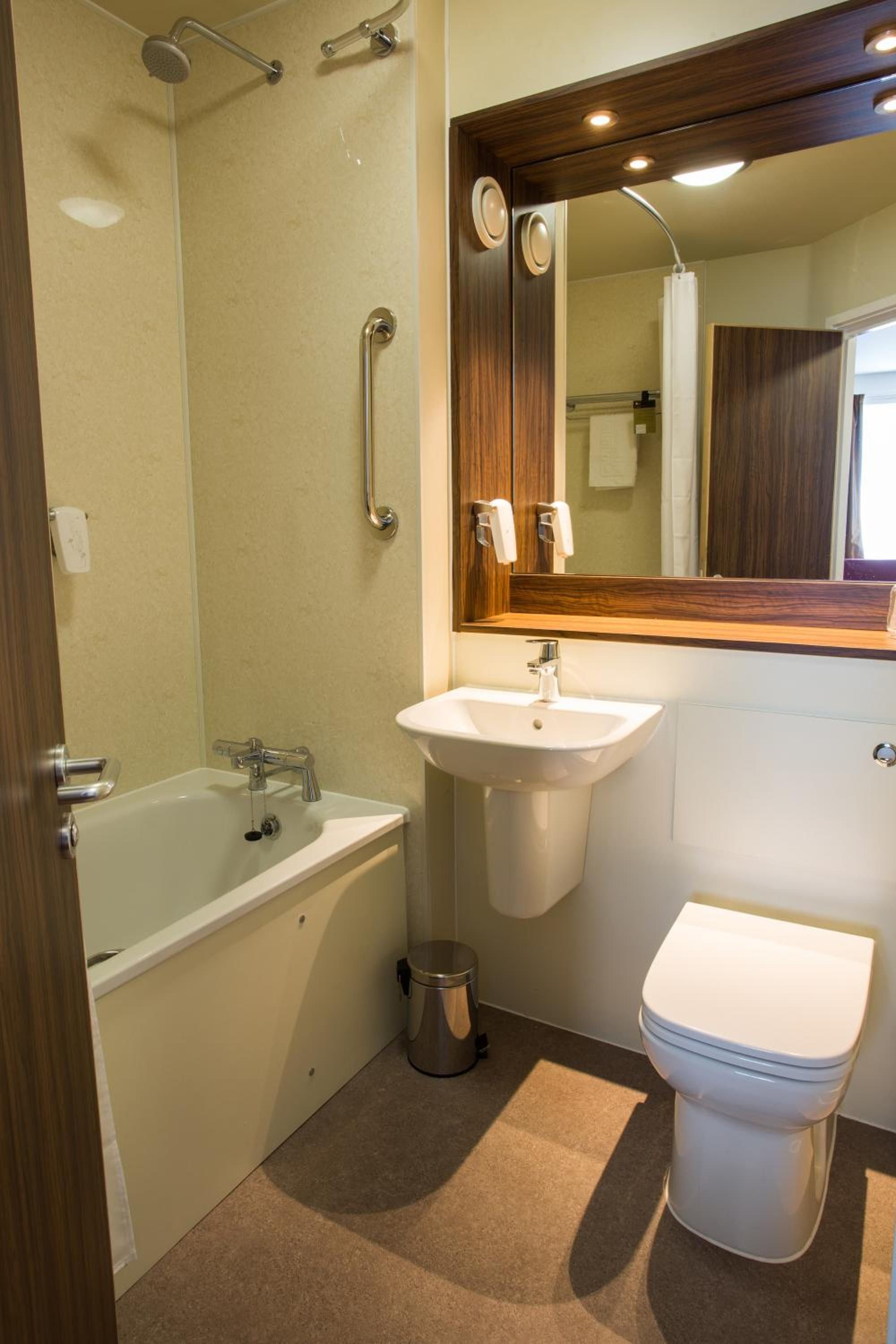 A bathroom with a bathtub, sink, and toilet.