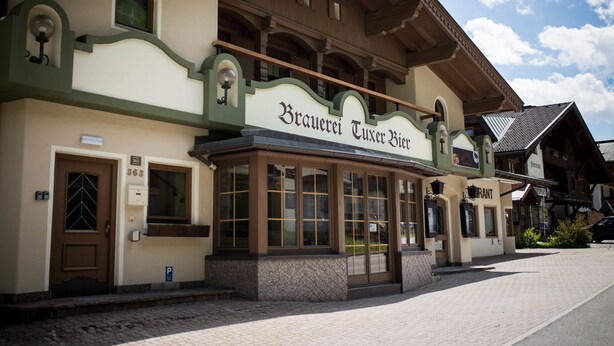 A traditional building with a sign reading "Brauerei Tuxer Hof". - Tuxie Haus (Tux)