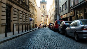 A cobblestone street lined with historic buildings, including a prominent building with a sign reading "Newtown." - Wenceslas Square Apartment (Prague)