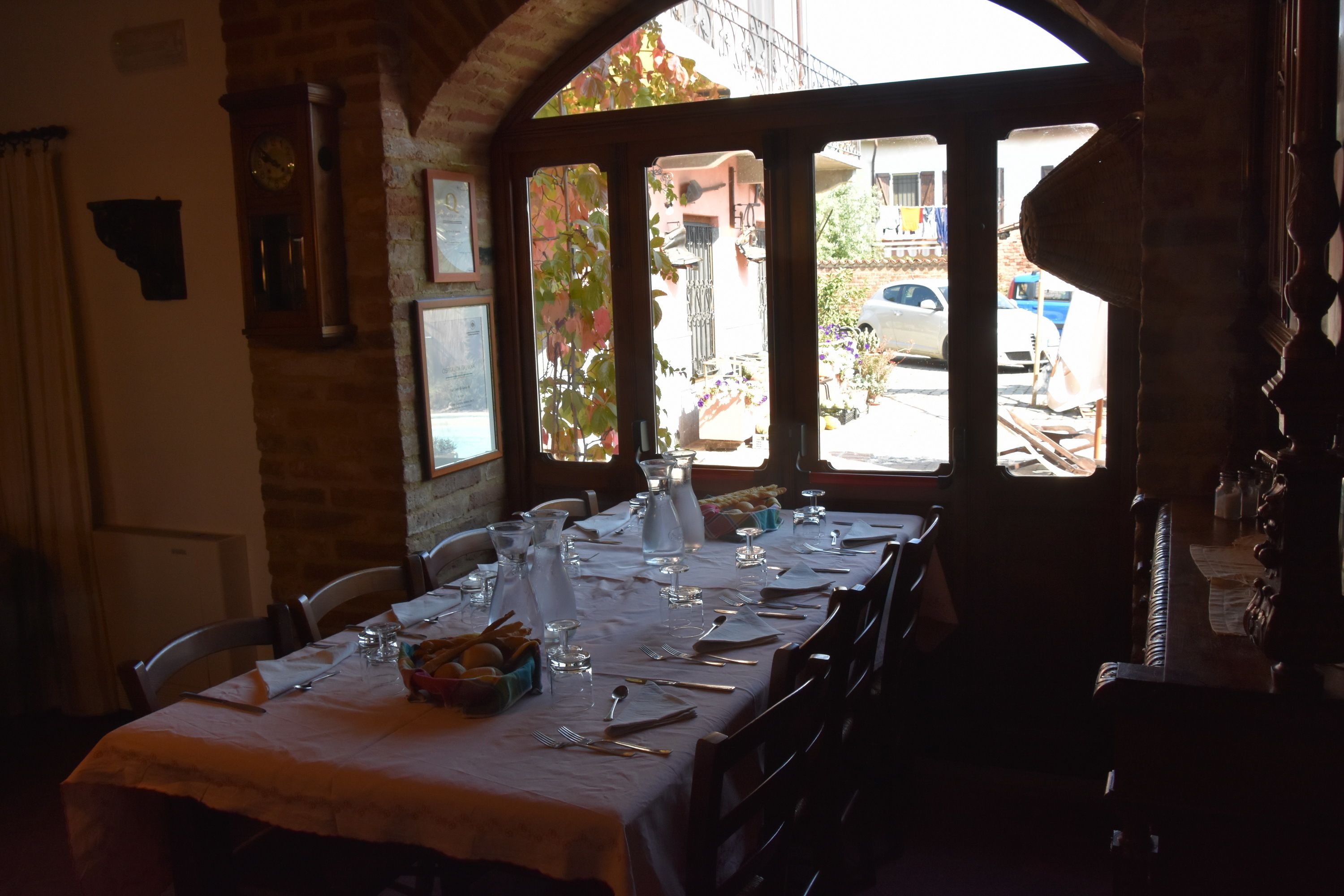 A dining area with a table set for four, including plates, glasses, and cutlery.