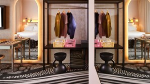 Quarto de hotel com cama, escrivaninha, cadeira, guarda-roupa e espelho.