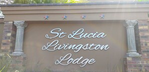 A sign for St. Lucia Livingston Lodge with decorative stars above the text. - St Lucia Livingston Lodge (St. Lucia)