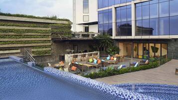 Outdoor pool, open 6:00 AM to 10:00 PM, pool umbrellas, sun loungers