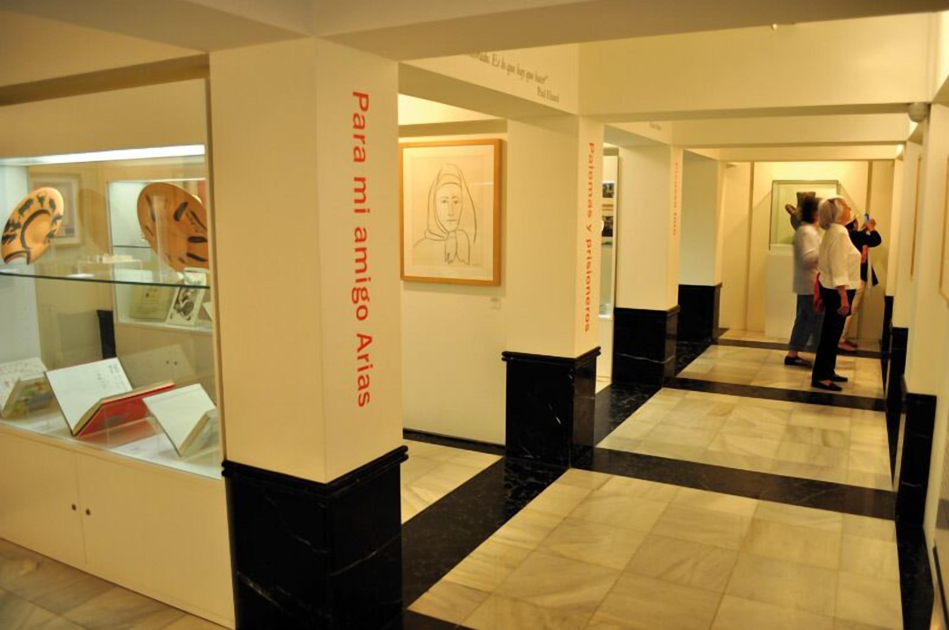 A museum corridor with glass display cases and informational panels.