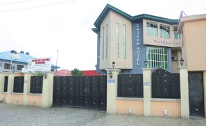 A building with a sign that reads "CHISAM HOTEL". - Emerald Hotel Annex (Port Harcourt)