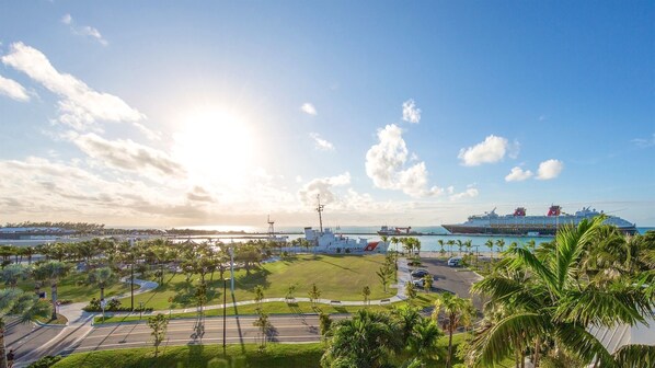 A coastal cityscape with a cruise ship docked, palm trees, and a clear sky. - **JASMINE JEWEL @ THE ANNEX** Lush Home & Pool + Last Key White Glove Service... (Key West)