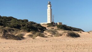 A lighthouse on a sandy hill with sparse vegetation. - House 4 Mar y Arena. Villa with private pool and all possible extras. (Barbate Cadiz)
