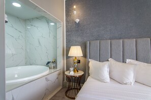 Executive Suite | Minibar, in-room safe, individually decorated, individually furnished