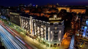 A multi-story hotel with a prominent "HOTEL LIDO" sign, located at a city intersection with visible traffic. - Lido by Phoenicia (Bucharest)