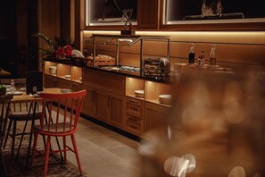 A modern kitchen with wooden cabinets, a breakfast bar, and a toaster.
