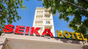 The entrance to Seika Hotel with a clear view of the building's facade, a staircase leading to the entrance, and a signboard displaying the hotel's name. - Seika Hotel (Ho Chi Minh City)