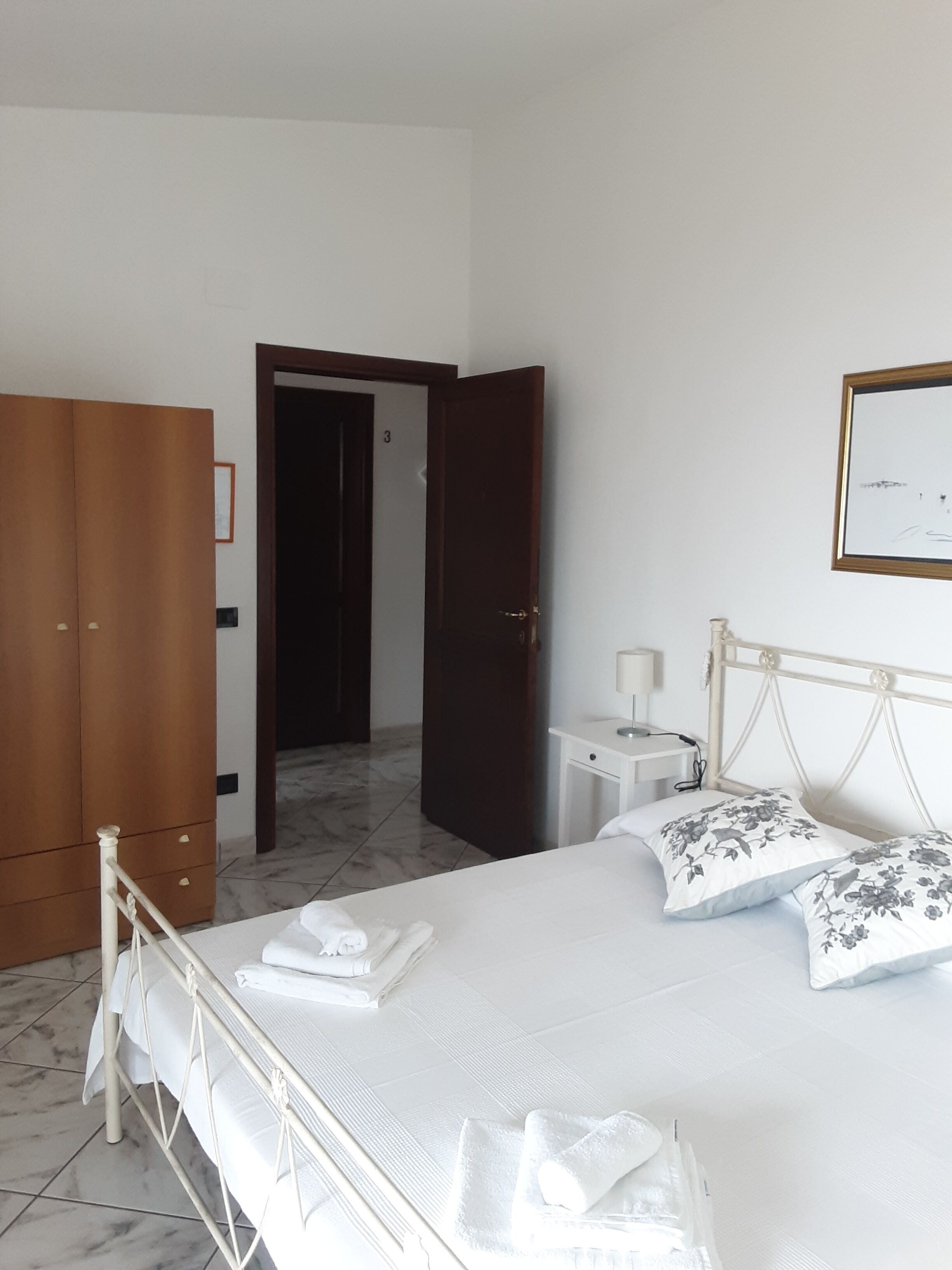 BAY-MOON APARTMENTS. Bedroom with double bed, bathroom, small terrace <br>view.