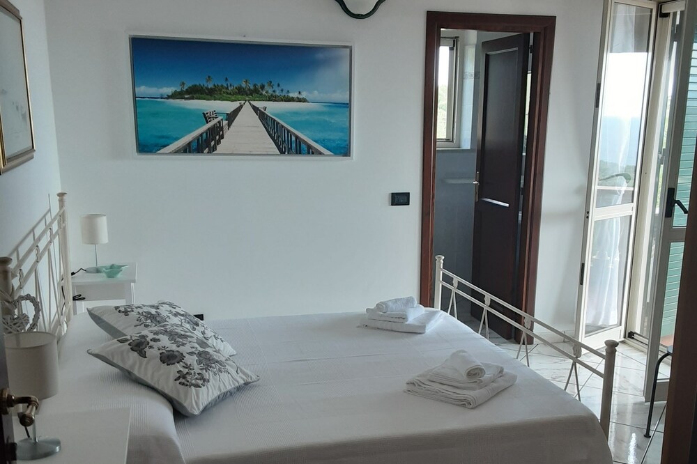 BAY-MOON APARTMENTS. Bedroom with double bed, bathroom, small terrace <br>view.
