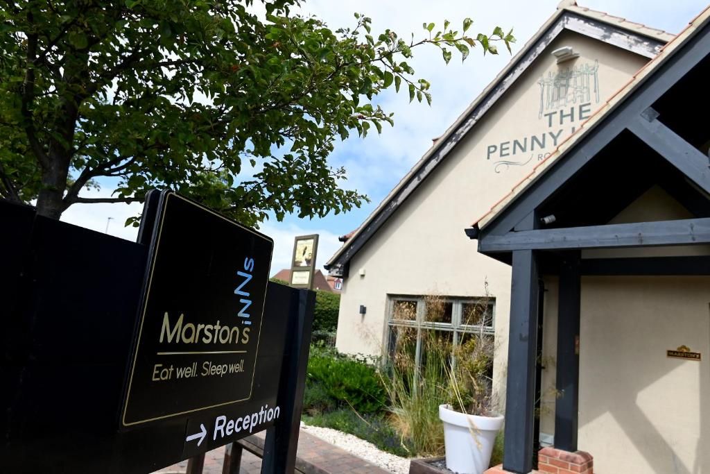 A reception sign for Marston's hotel with a clear path to the reception area.