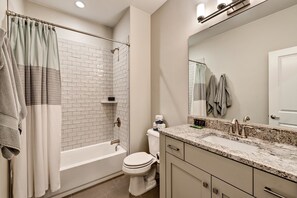 A bathroom with a shower, toilet, and sink. - Zane's Place (St. George)