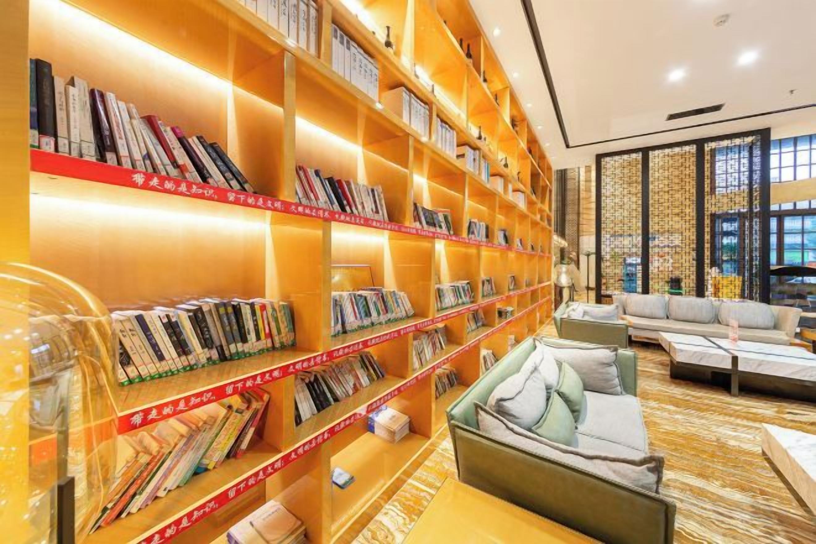 A library with bookshelves, a sofa, and a coffee table.