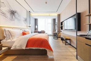 A modern hotel room with a bed, a TV, a desk, and a large window. - Times Holiday Hotel (Liupanshui)