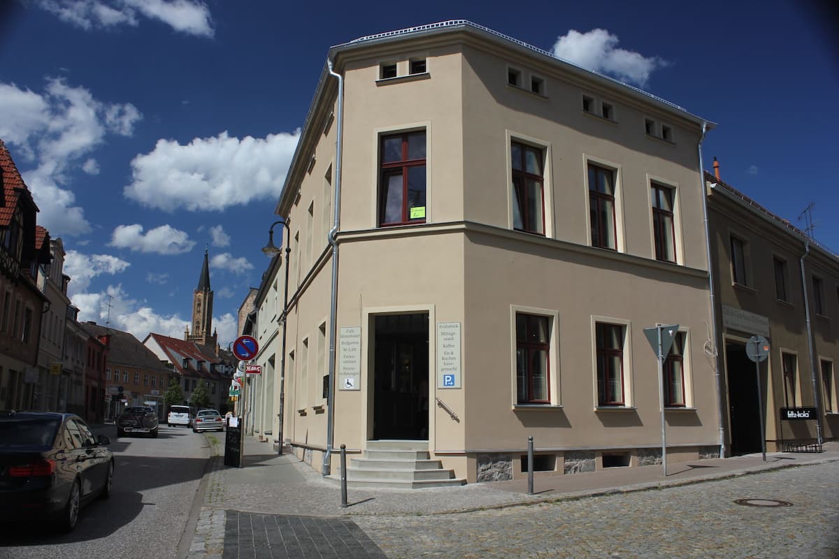 A building with a beige facade, multiple windows, and a visible entrance.
