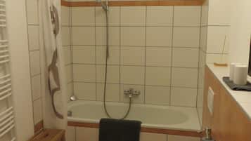 Bathtub, hair dryer, towels, soap