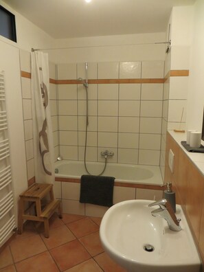 Bathtub, hair dryer, towels, soap