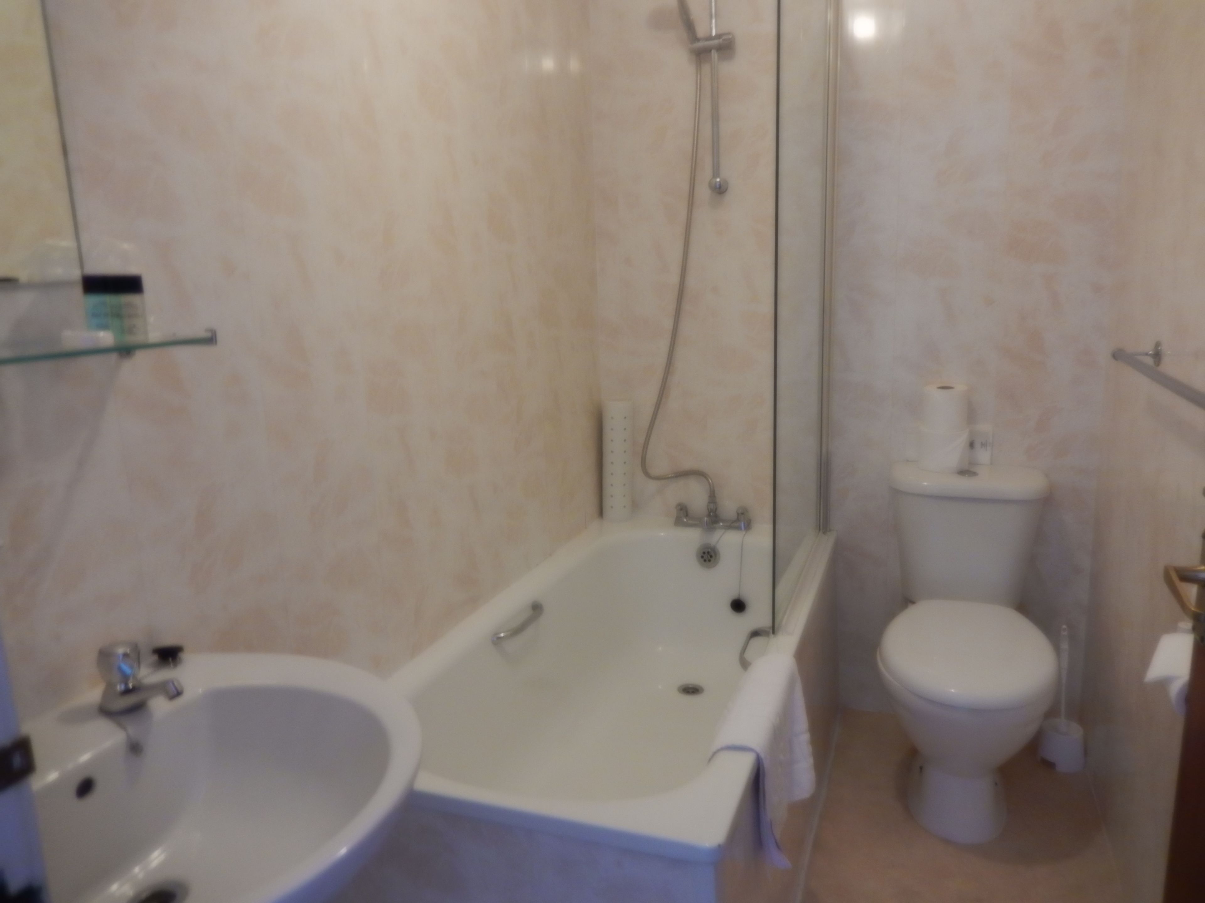 A bathroom with a bathtub, a sink, and a toilet.